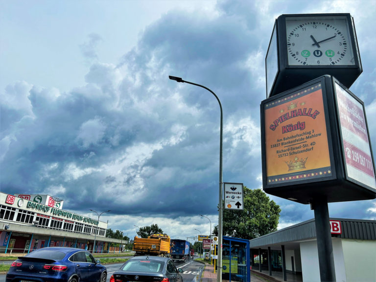 Uhrenwerbung auf einer Straße für eine Spielhalle.