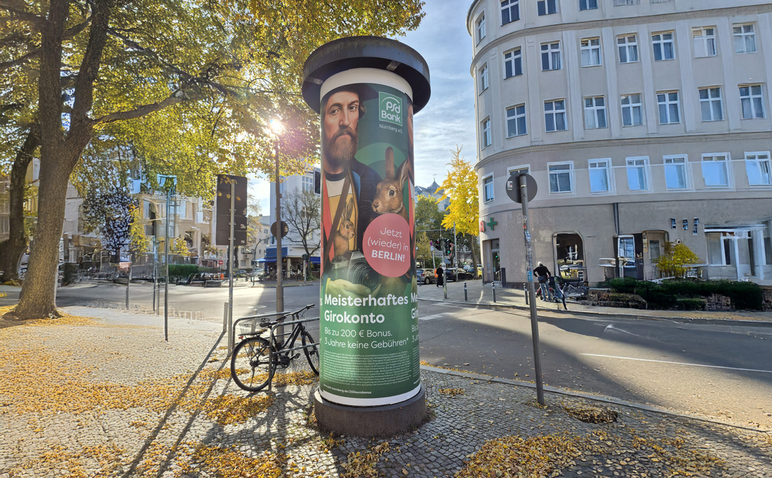 Litfaßsäule mit mehreren Werbeplakaten einer Bank zur Bewerbung von Girokonten.